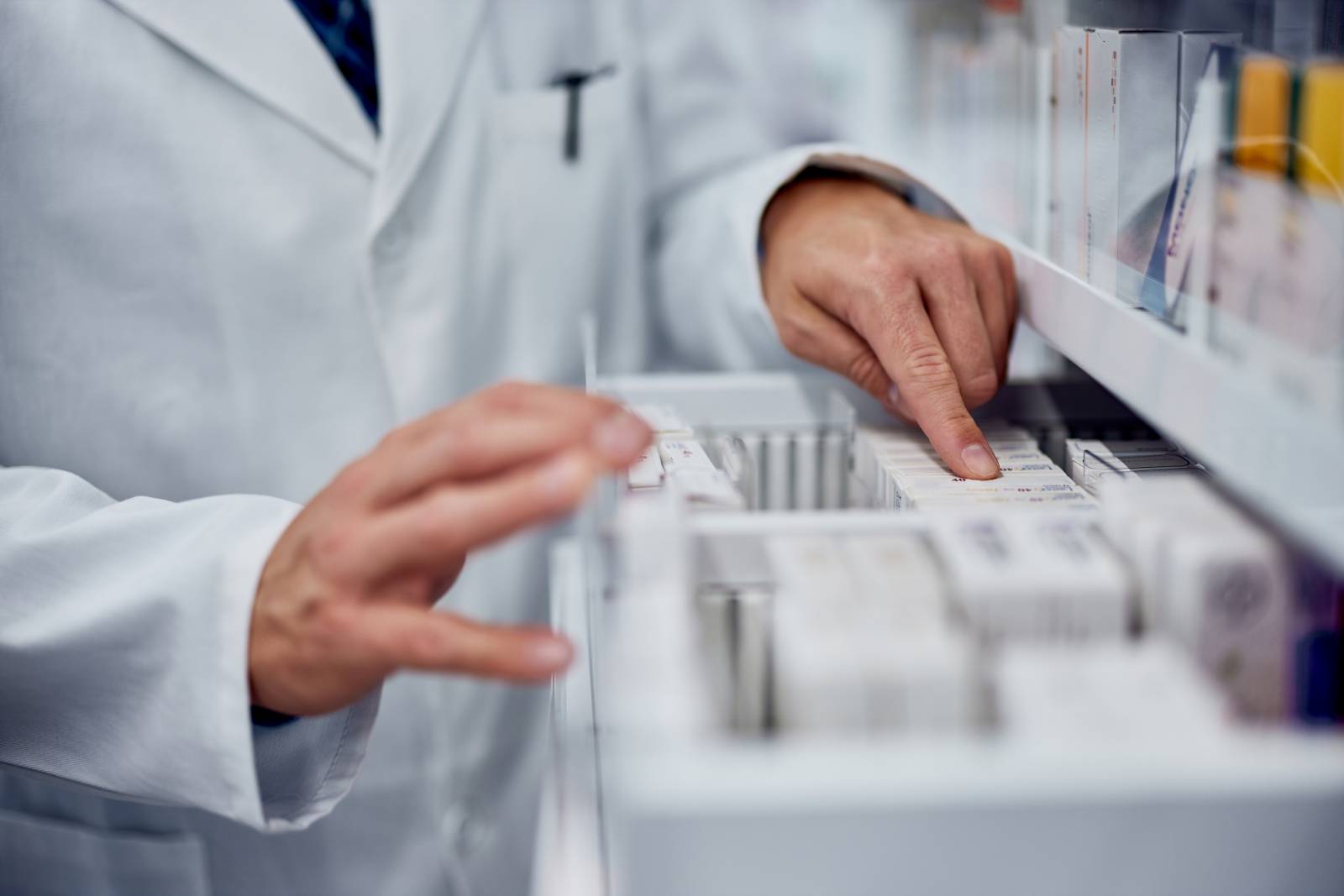 close up of a male pharmacist checking drawer