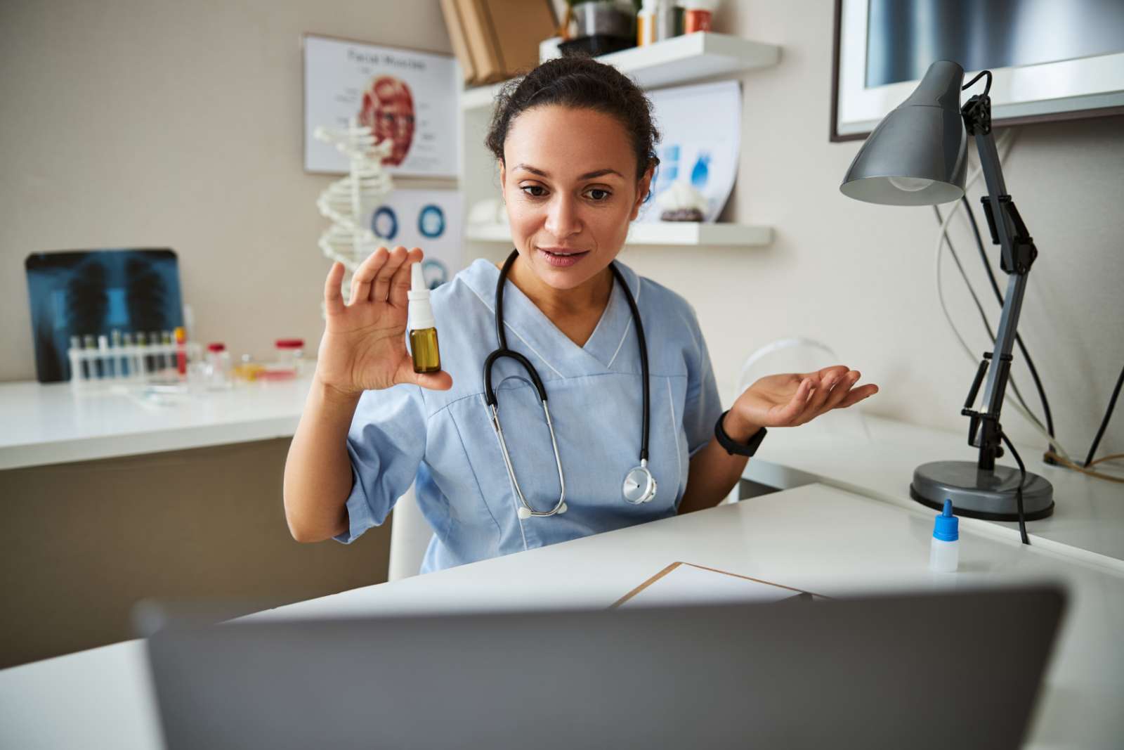 doctor showing nose spray during an online call