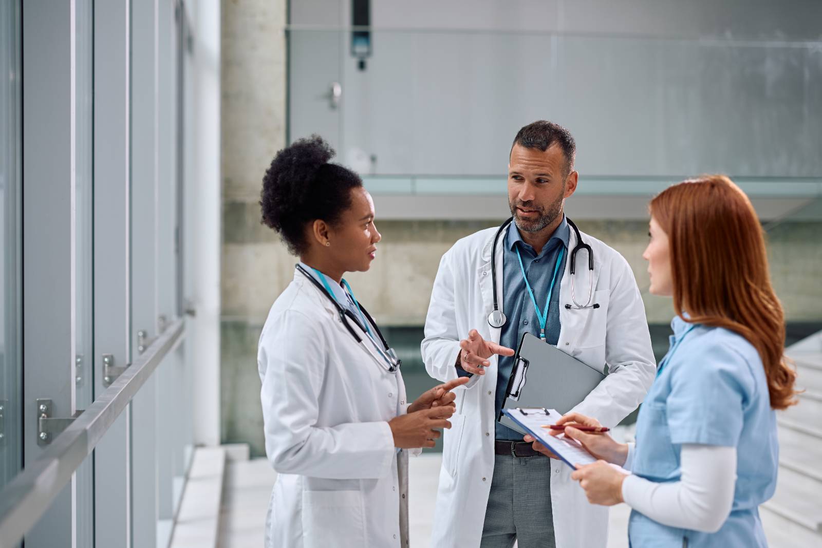 team of medical experts talking in hallway